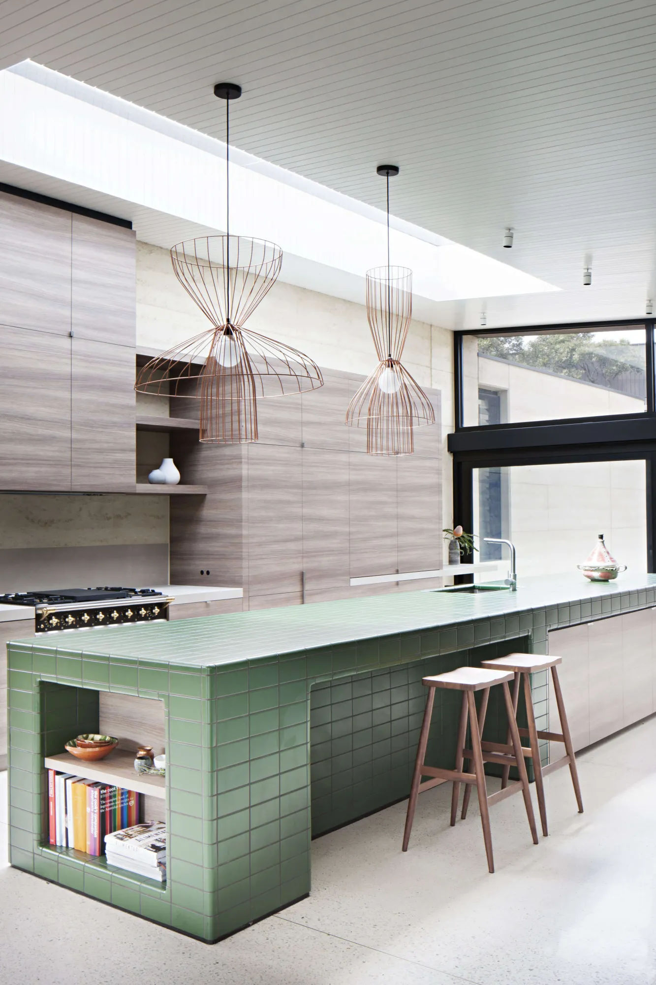 Tiled kitchen island in contemporary wood kitchen at Layer House by Robson Rak architects