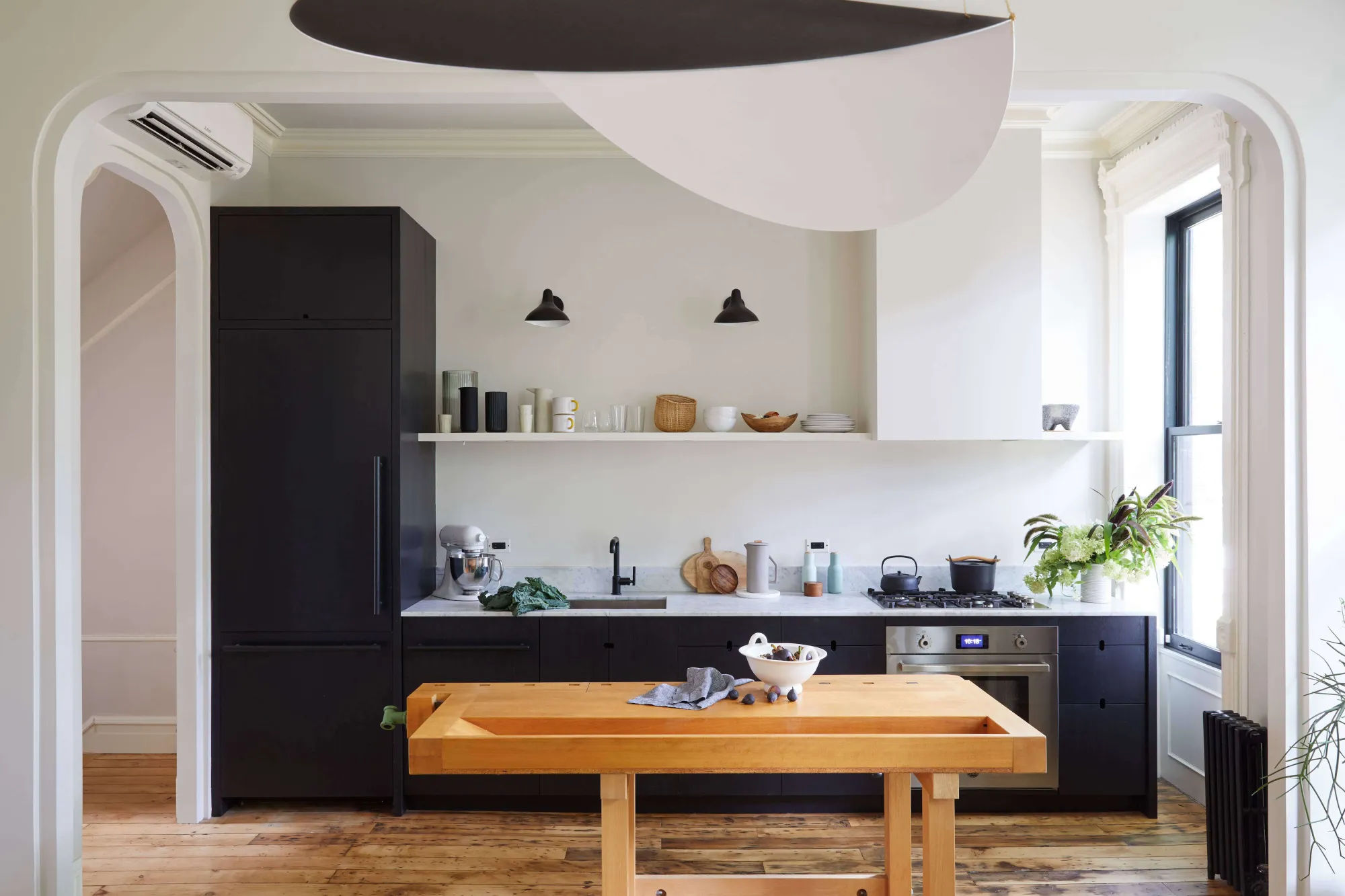 Small streamlined Brooklyn kitchen with black cabinets by architect Jess Thomas