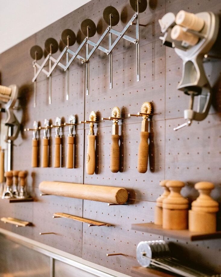 tools are hung from simple brass nails slotted into a pegboard, and the display 16