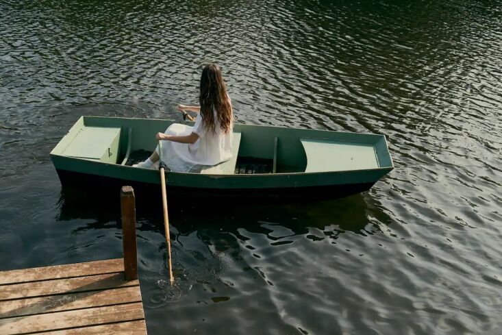 alice rowing in a wood boat that seats up to five people. they found the boat o 32