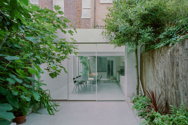 smooth poured concrete floors start in the garden, with its leafy fig and bay t 17