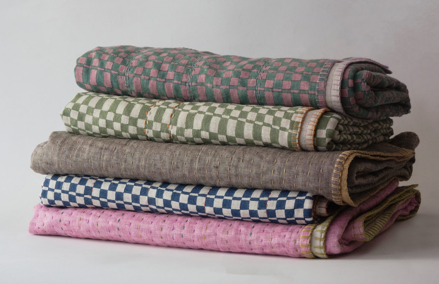 a sampling of opticality fabrics made into hand stitched and embroidered bed th 23