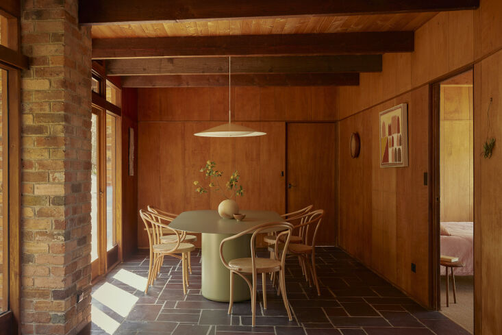 in the wood paneled dining room, thonet dining chairs surround the sequence din 24