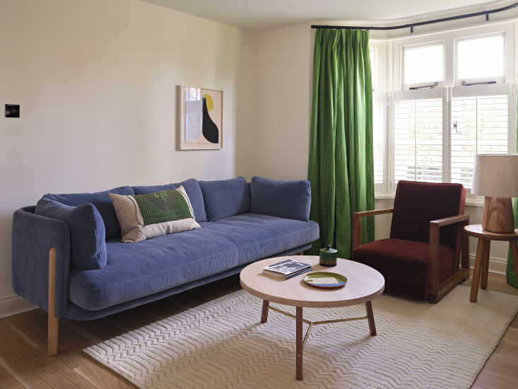 the adjacent living room is anchored by a cornflower corduroy slow sofa, anothe 22