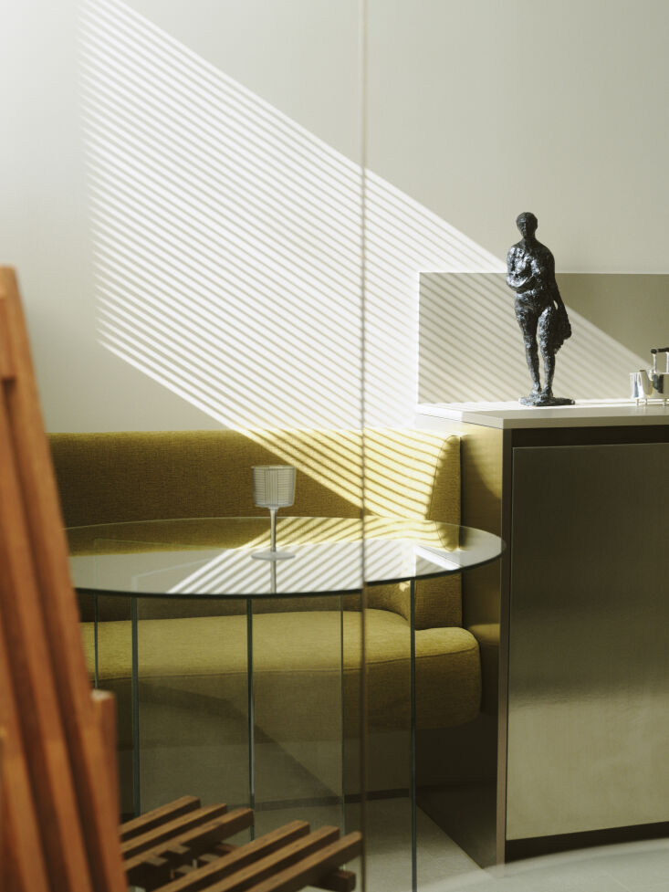 the kitchen leads to a built in bench set into a rounded, semi circular alcove  24