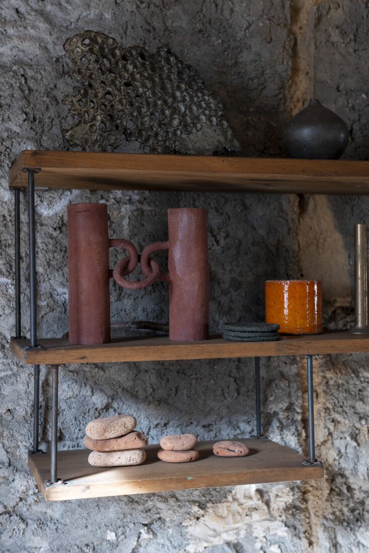 modernist open shelves display ceramics and beach terracotta. 19