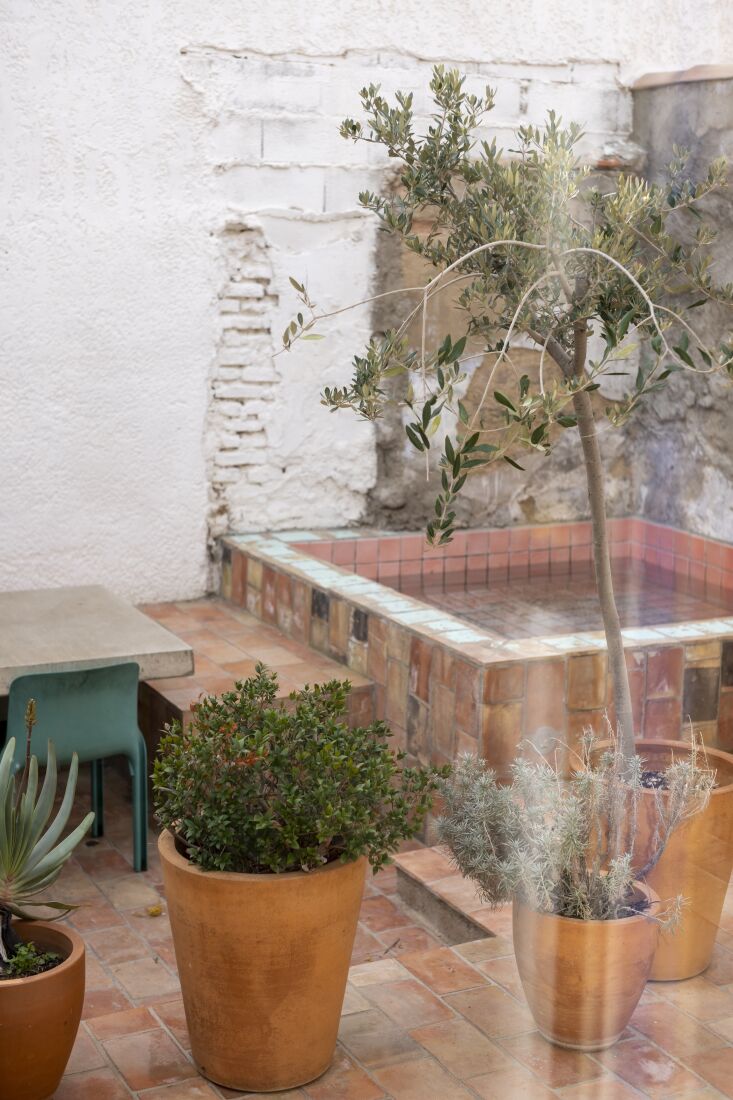 the terracotta lined terrace has a concrete table and a plunge pool. 26