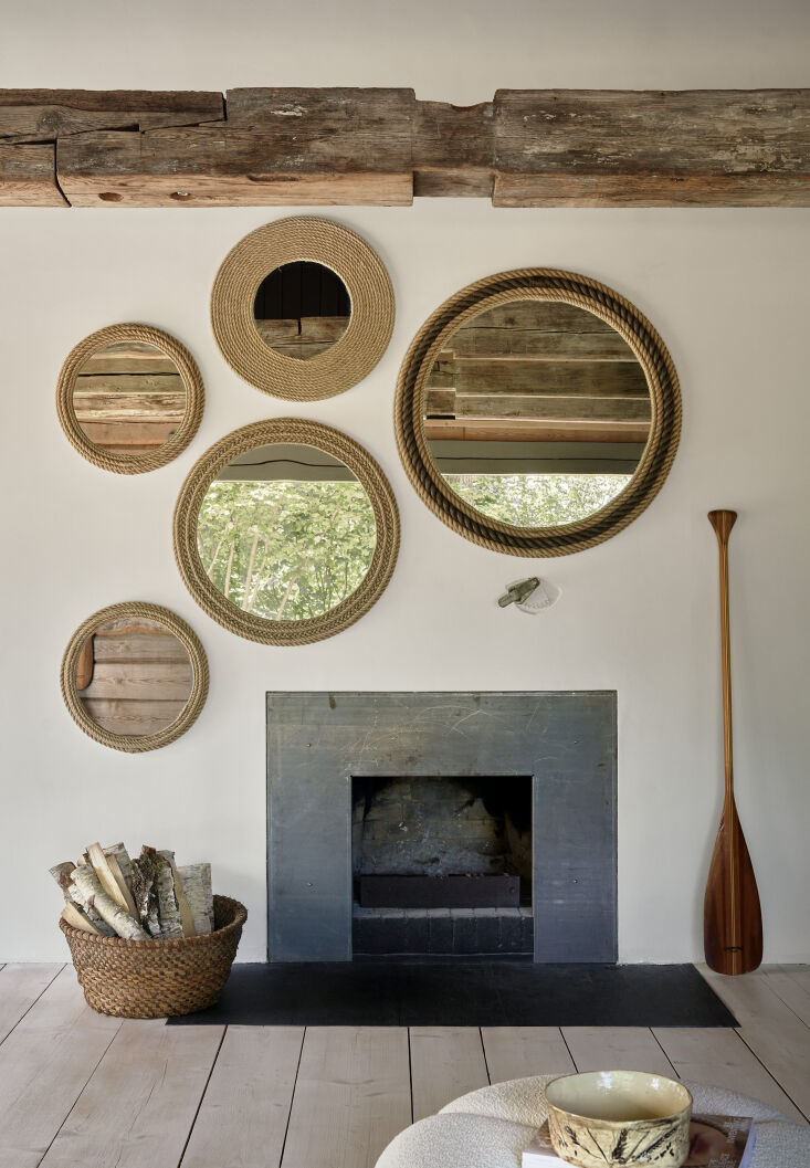 mirrors around the fireplace serve to reflect light and the nearby trees— 21