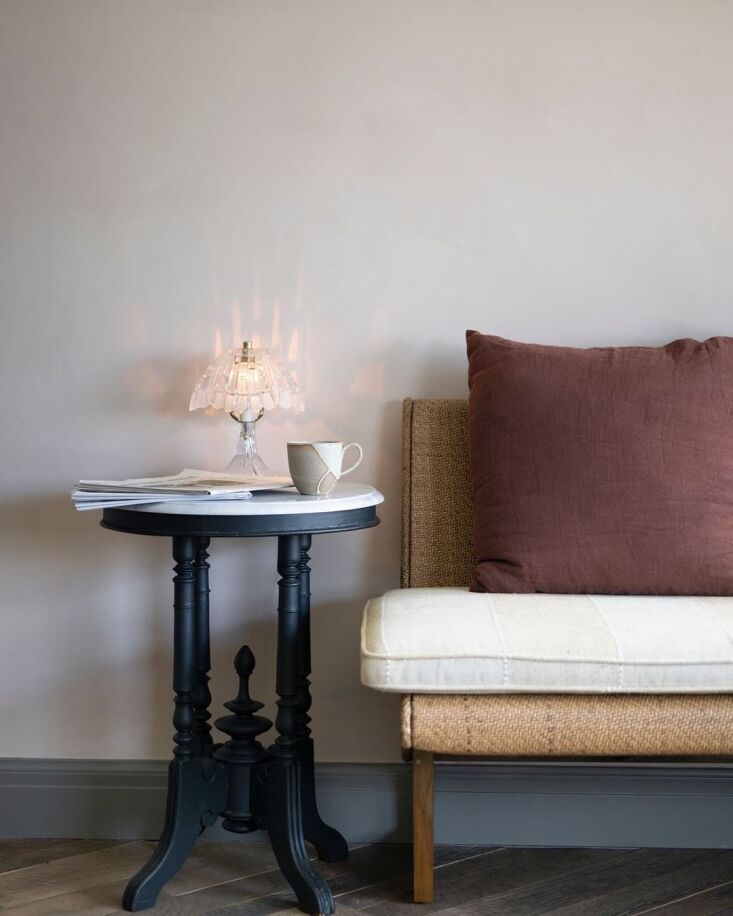 an ornate vintage side table and small table lamp paired with a modern, custom  32