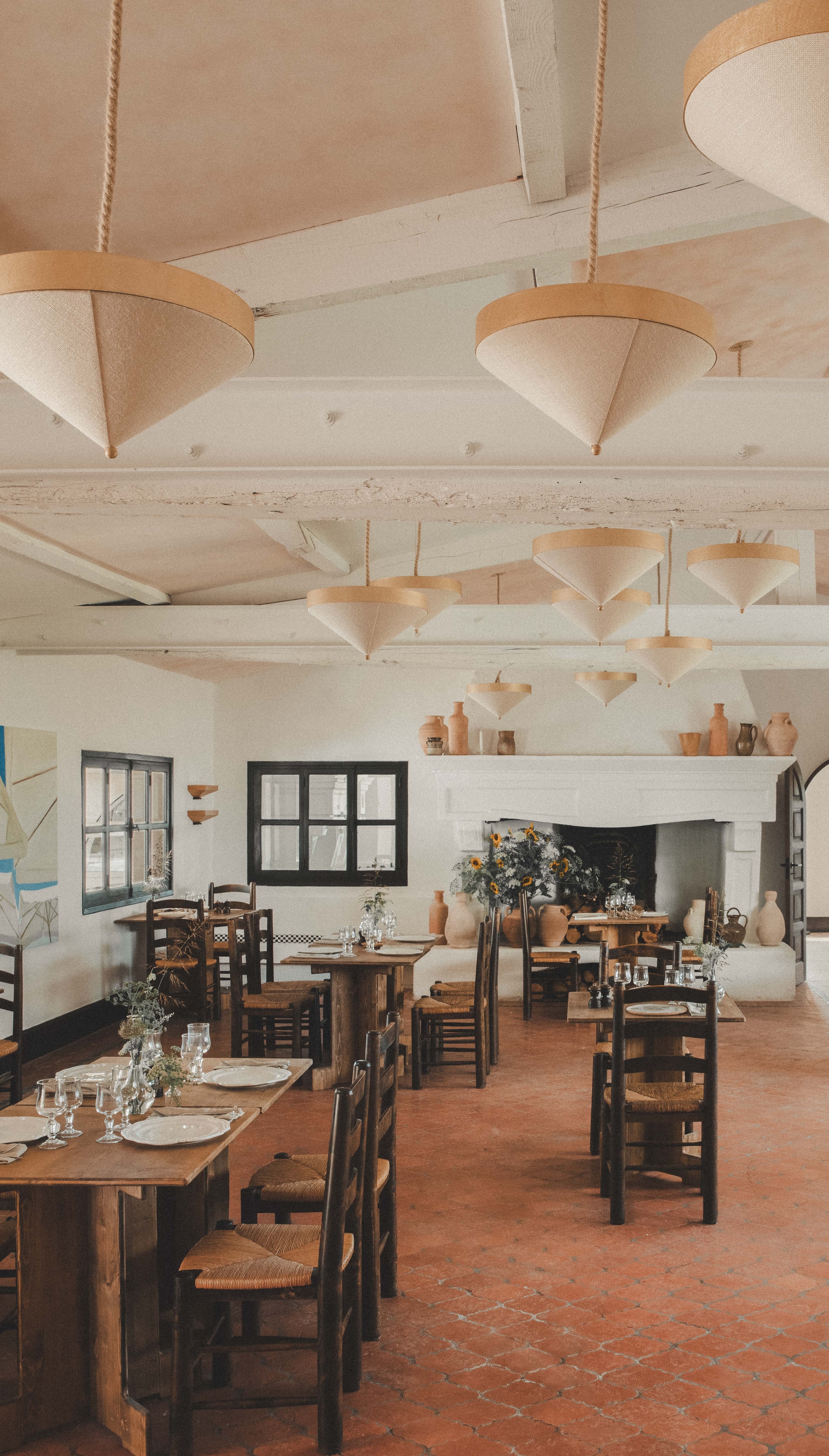 custom pendant lights hang over the airy dining room. 27