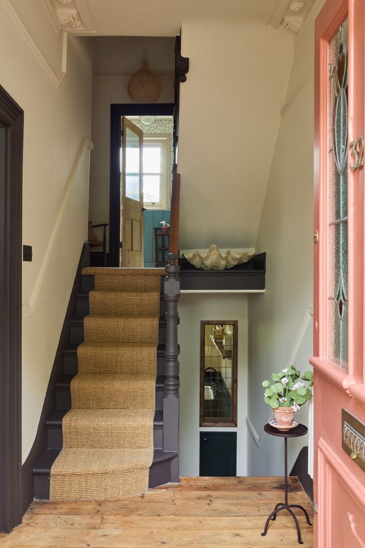 the front door, painted in farrow & ball&#8\2\17;s book room red, opens 17