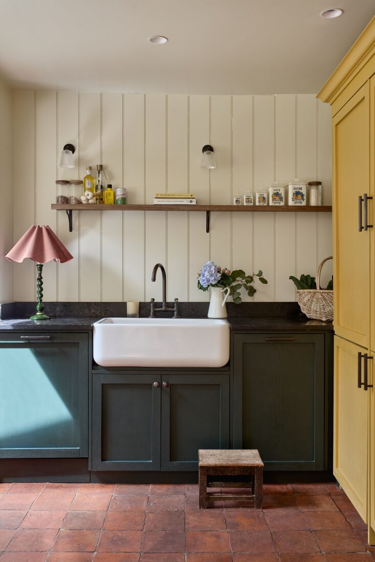 laura pushed lucy to go bold with color, covering the cabinetry in dark studio  19