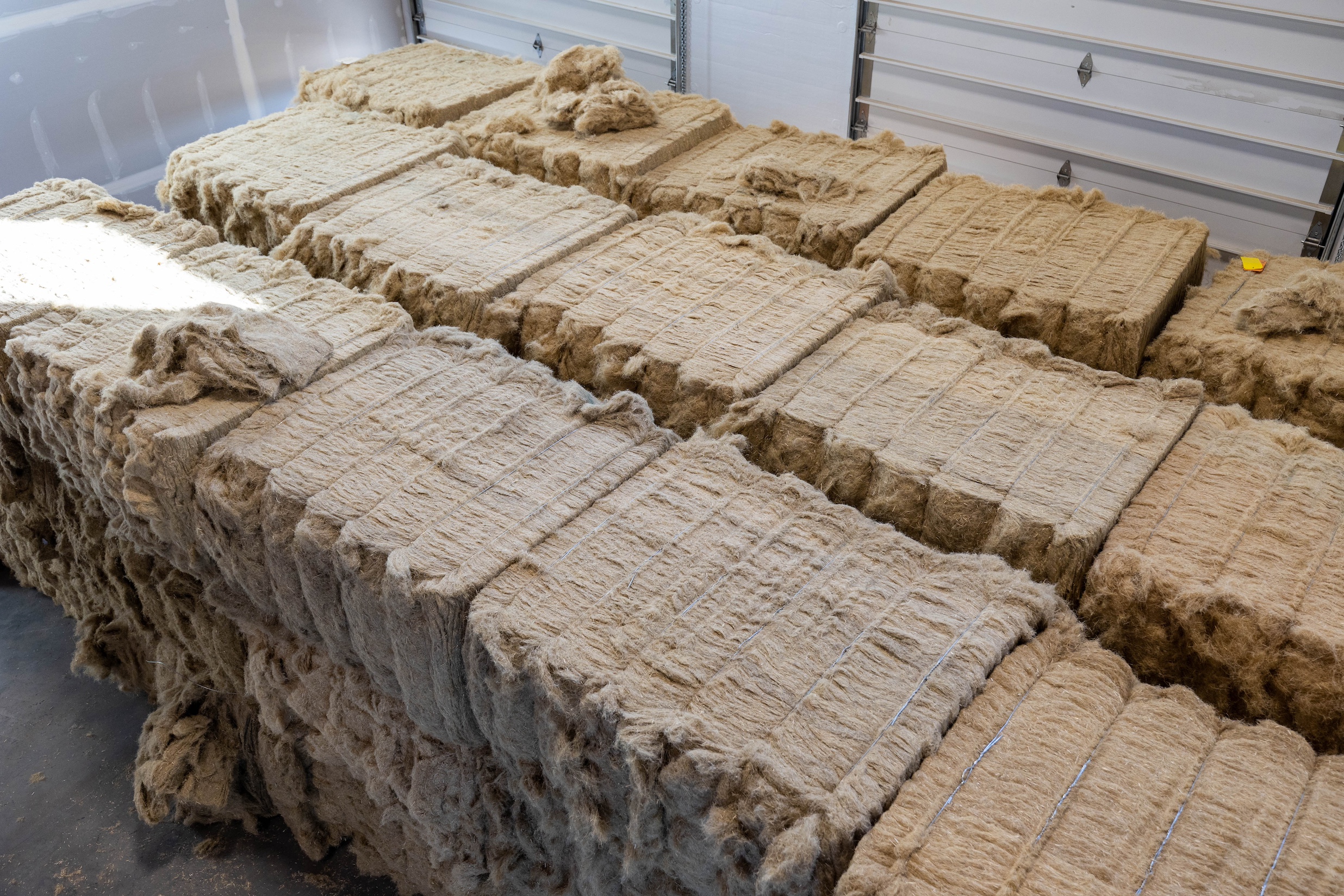 at hemptitecture, bales of decorticated industrial hemp fiber await being conve 18