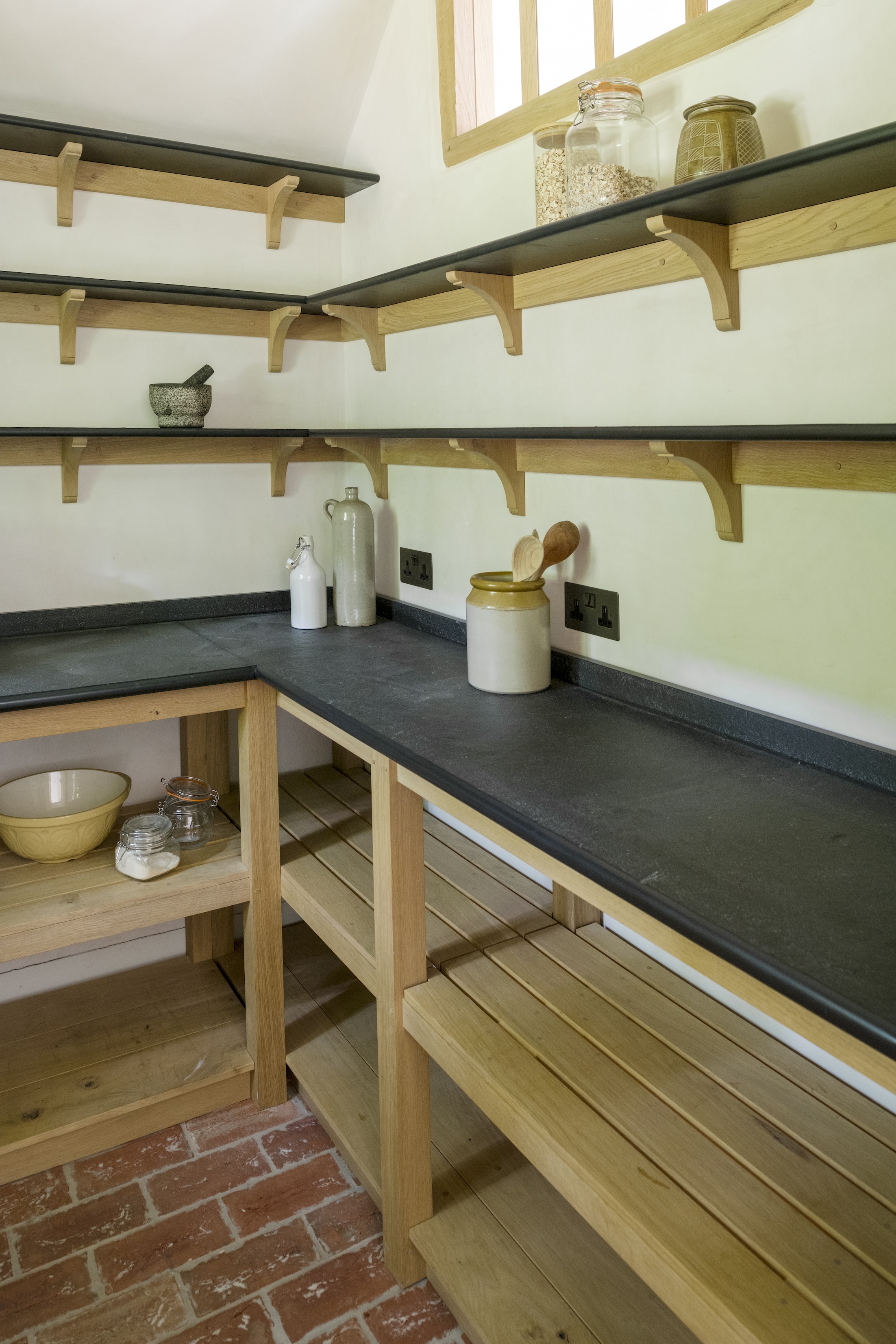 the pantry has oak storage—note the peg joinery—as well as a coun 23