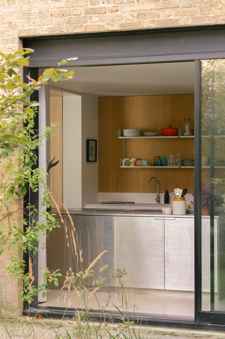 sliding doors open into the kitchen, done in stainless steel and white oak. 18