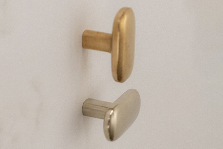 the oval knob/hook is available in a polished natural bronze, polished white br 18