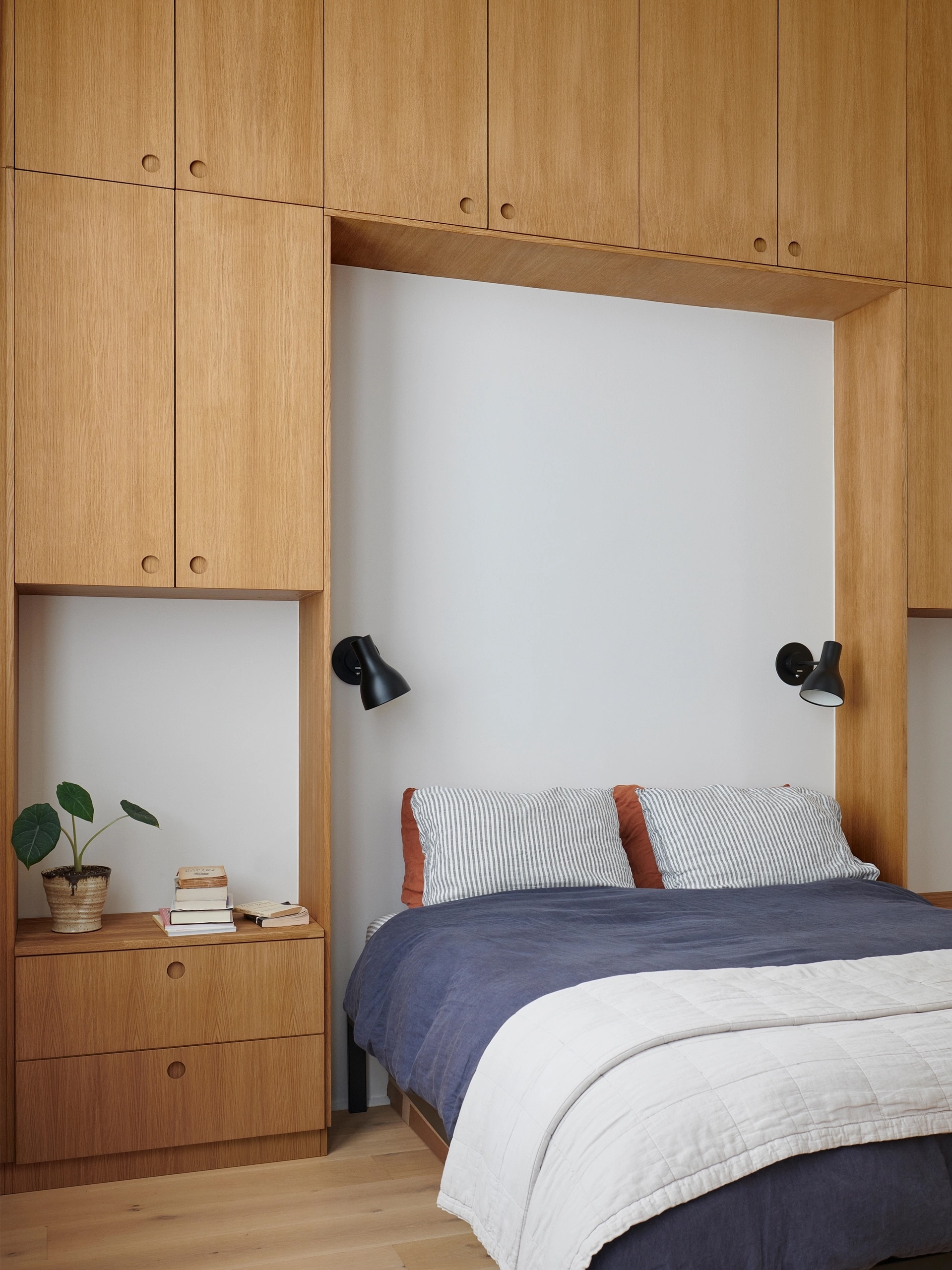 the cabinets can be put to use around beds as unobtrusive storage, here basis d 24