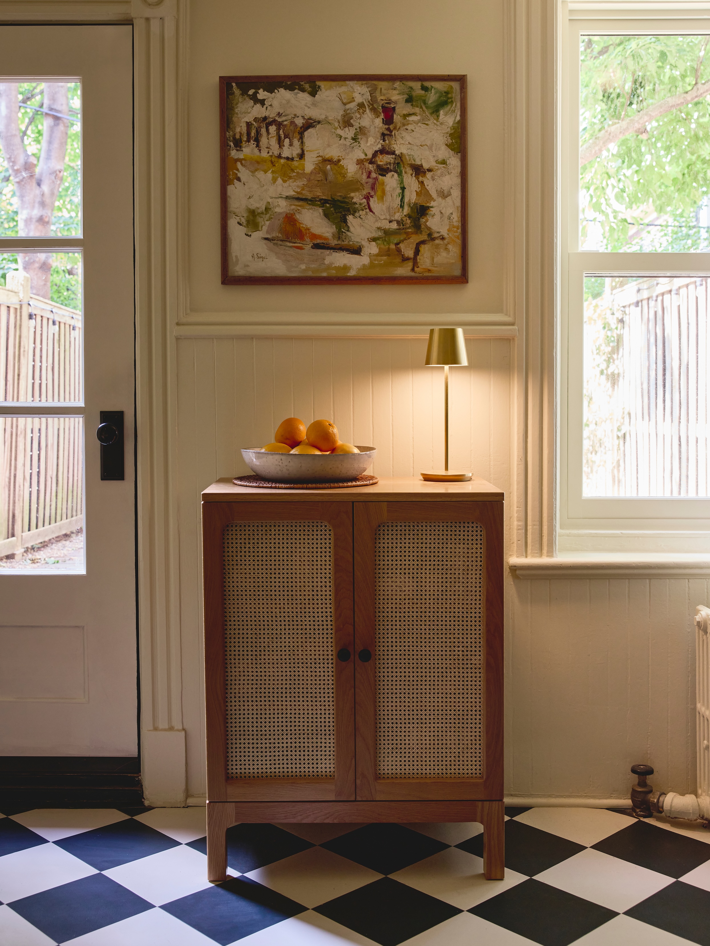 an old looking new door opens to the backyard. the caned oak cabinet is the \2  23