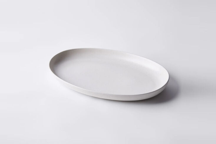 the casafina modern classic ceramic oval serving platter, shown in cream, is \$ 21