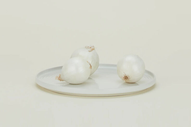 the hawkins new york essential serving platter in bone is \14 inches round; \$3 23