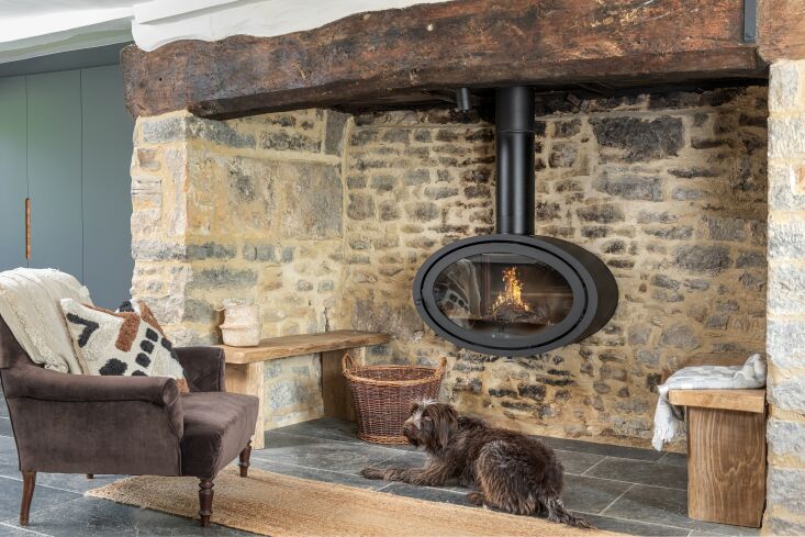 the family pup, kit, lounges in front of the \1400s fireplace, which once conta 23