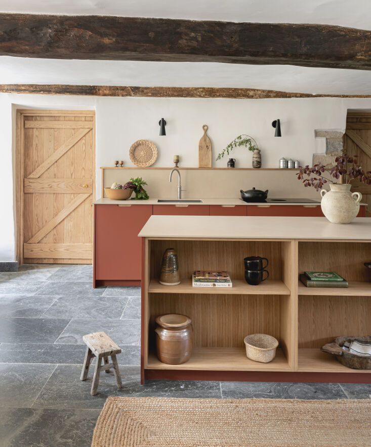 the large center island is equipped with oak veneer cubbies for displaying belo 20