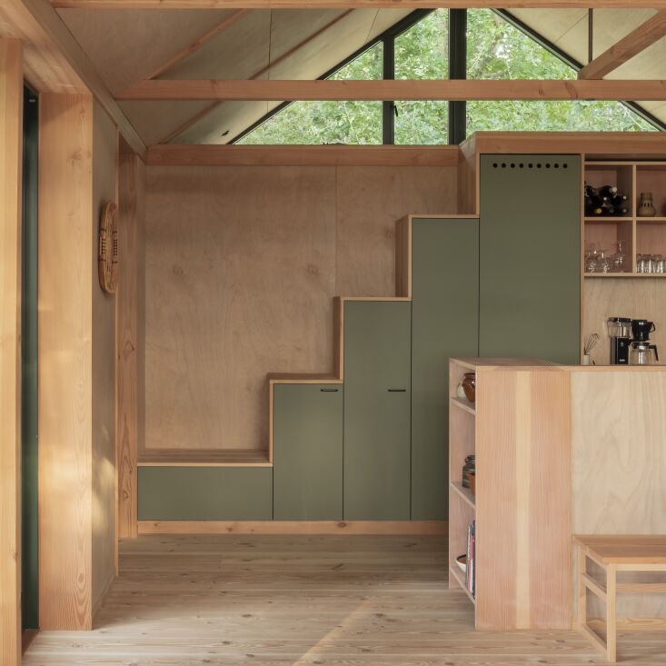 kitchen cabinetry (including a concealed fridge) doubles as a stair to the loft. 20