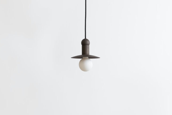 hanging above the laundry room sink is the smaller workstead orbit cord pendant 26