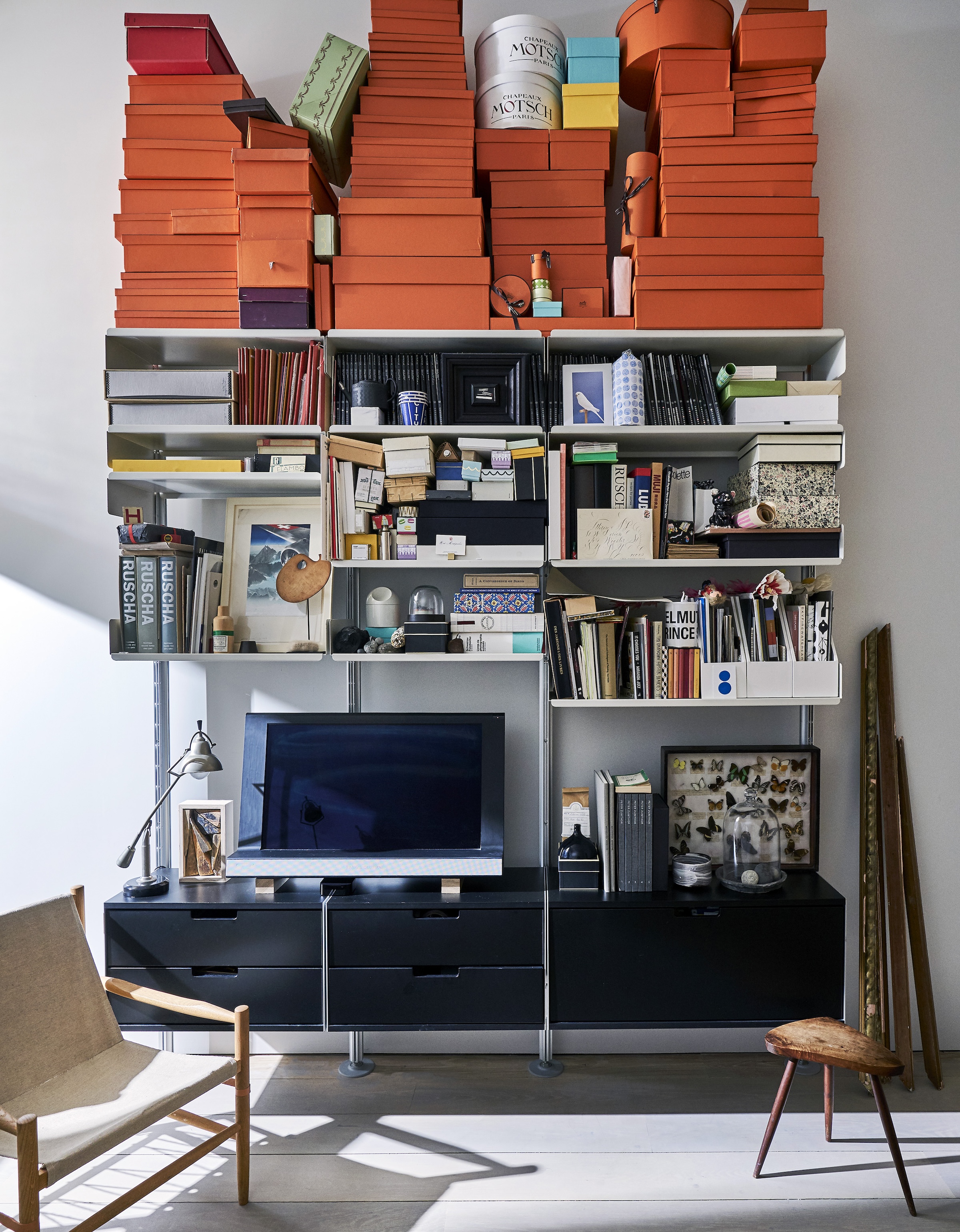 the bedroom has its own vitsoe sideboard and shelves, topped with a mountain of 30