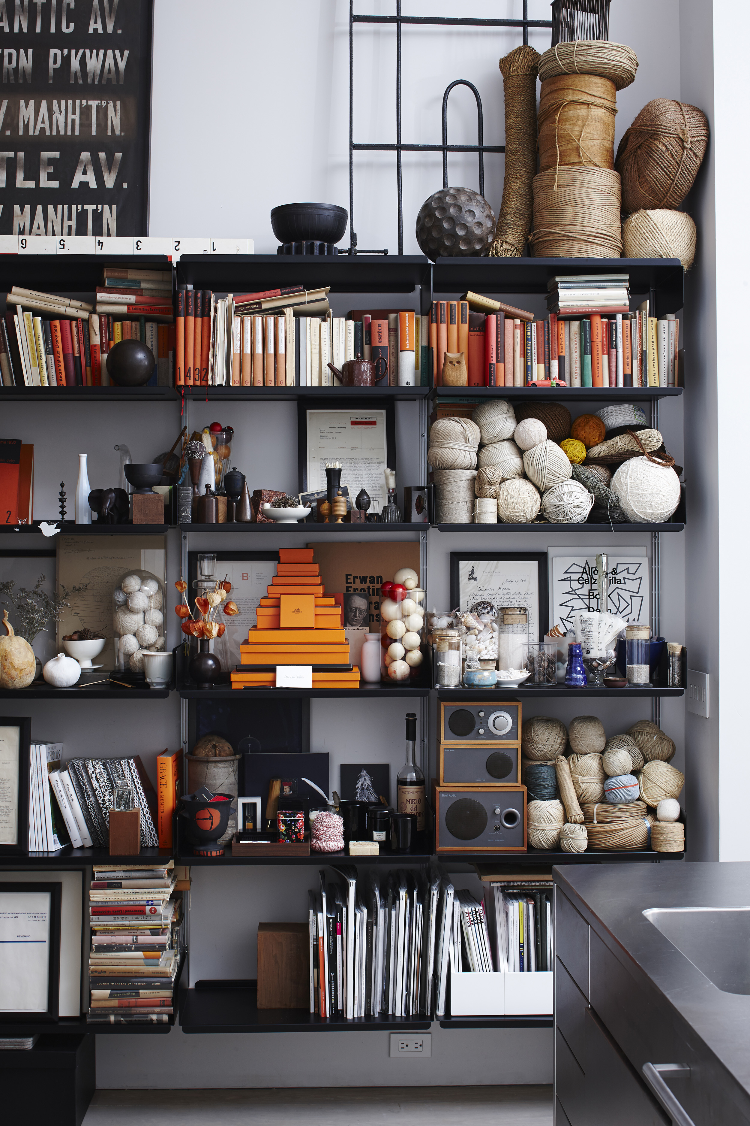 a packed set of vitsoe shelves create a hallway into the home office. photograp 25